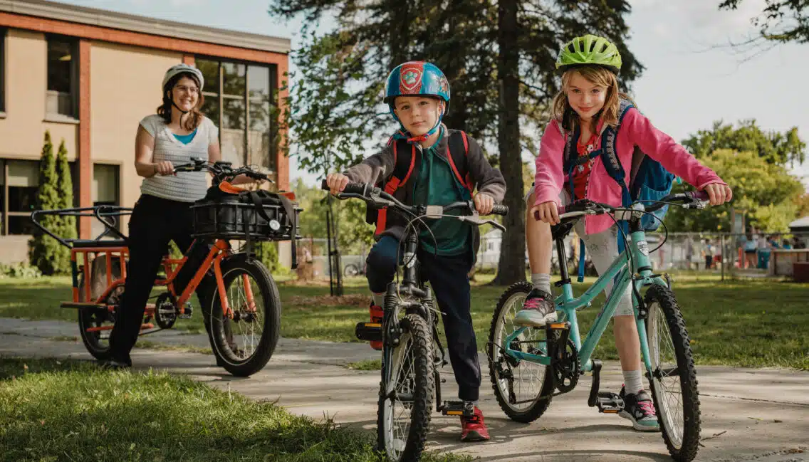 Mère à vélo avec ses deux enfants